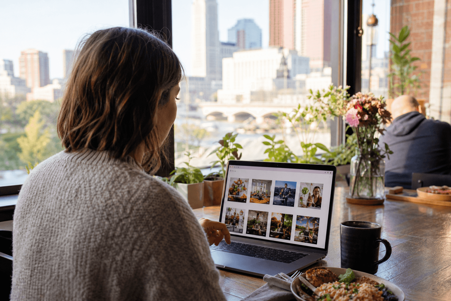 Person browsing local deals and services on a laptop in a bright cafe